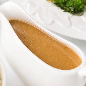 A gravy boat of made-from-scratch Turkey Gravy for a Thanksgiving Turkey.