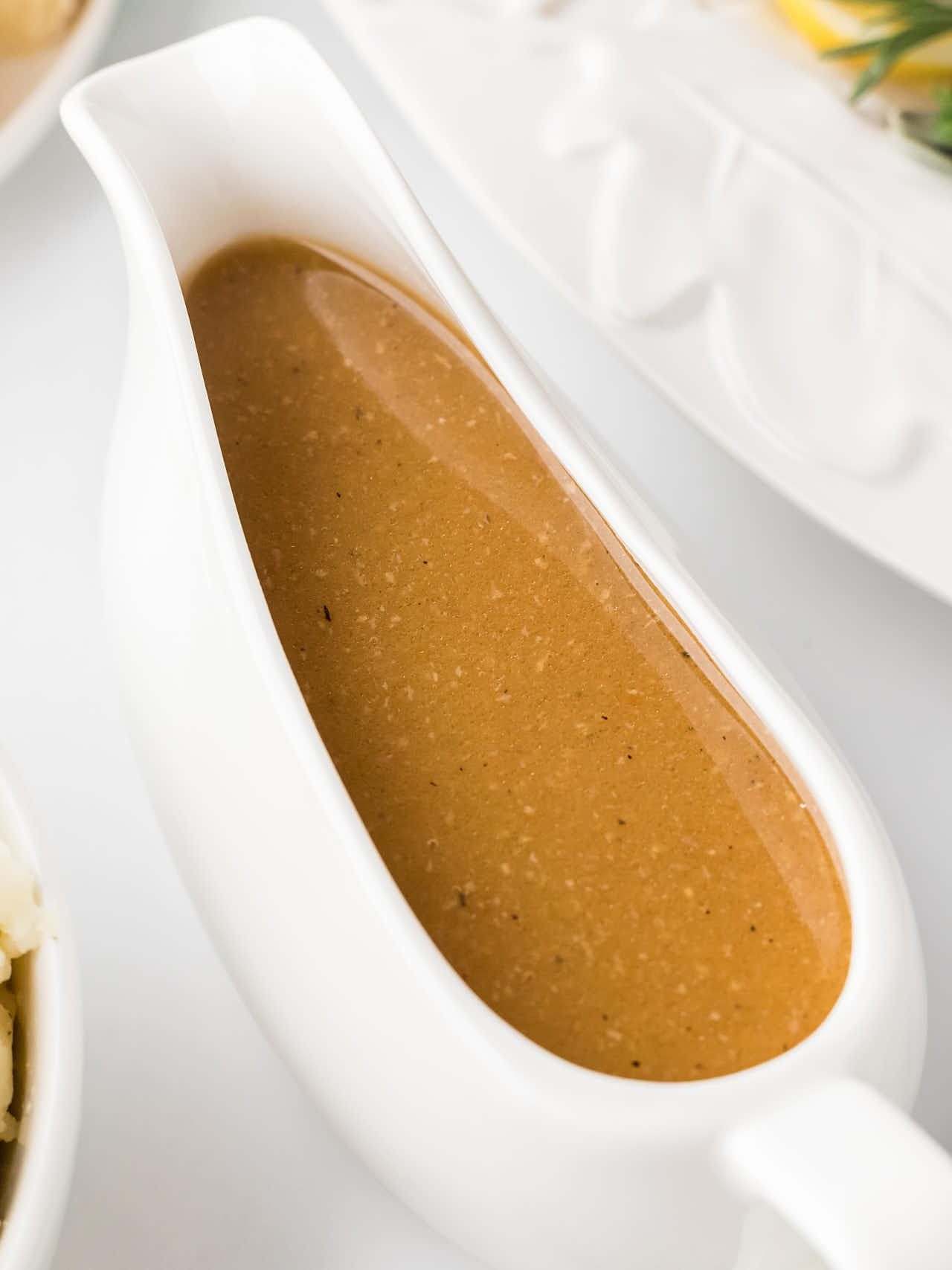 A gravy boat of homemade Turkey Gravy for a Thanksgiving Turkey.