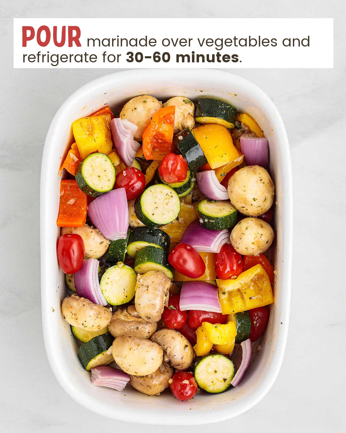 Veggie chunks covered with a marinade in a white dish.