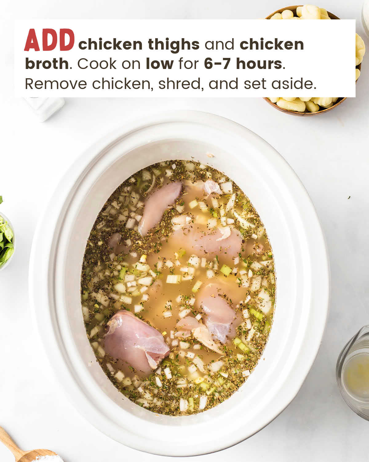 Chicken thighs in chicken broth with diced onion, carrots, celery, garlic, salt, pepper, celery seed, dried basil, and thyme in a large slow cooker.