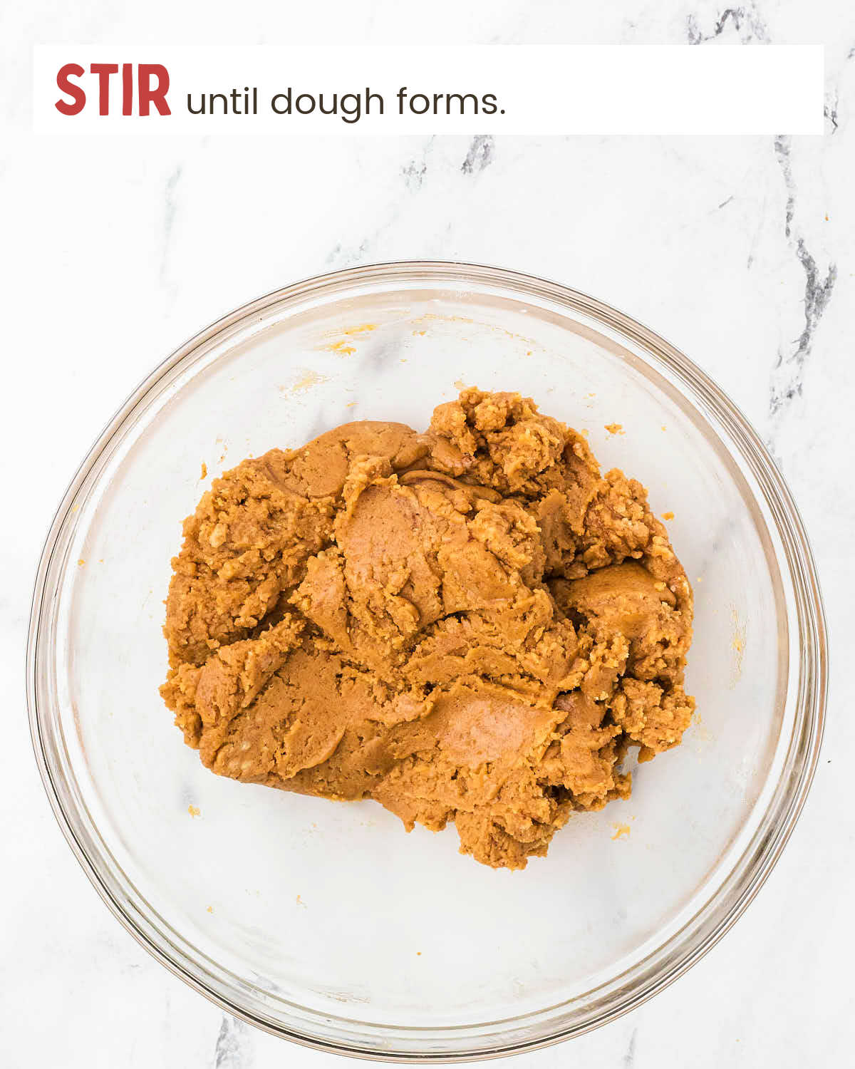 Pumpkin cookie dough in a glass bowl.
