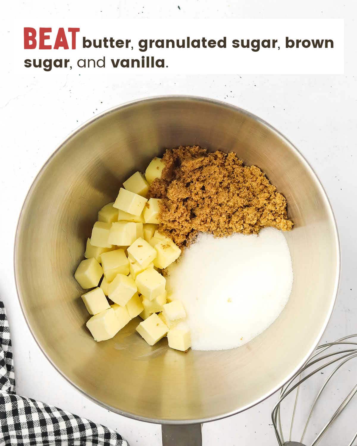 Butter cubes, sugar, brown sugar, and vanilla in a metal mixing bowl.