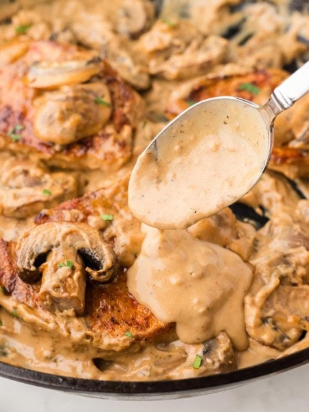 Closeup of Cream of Mushroom Pork Chops in a cast iron skillet.