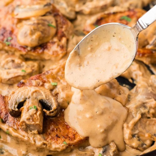 Closeup of Cream of Mushroom Pork Chops in a cast iron skillet.