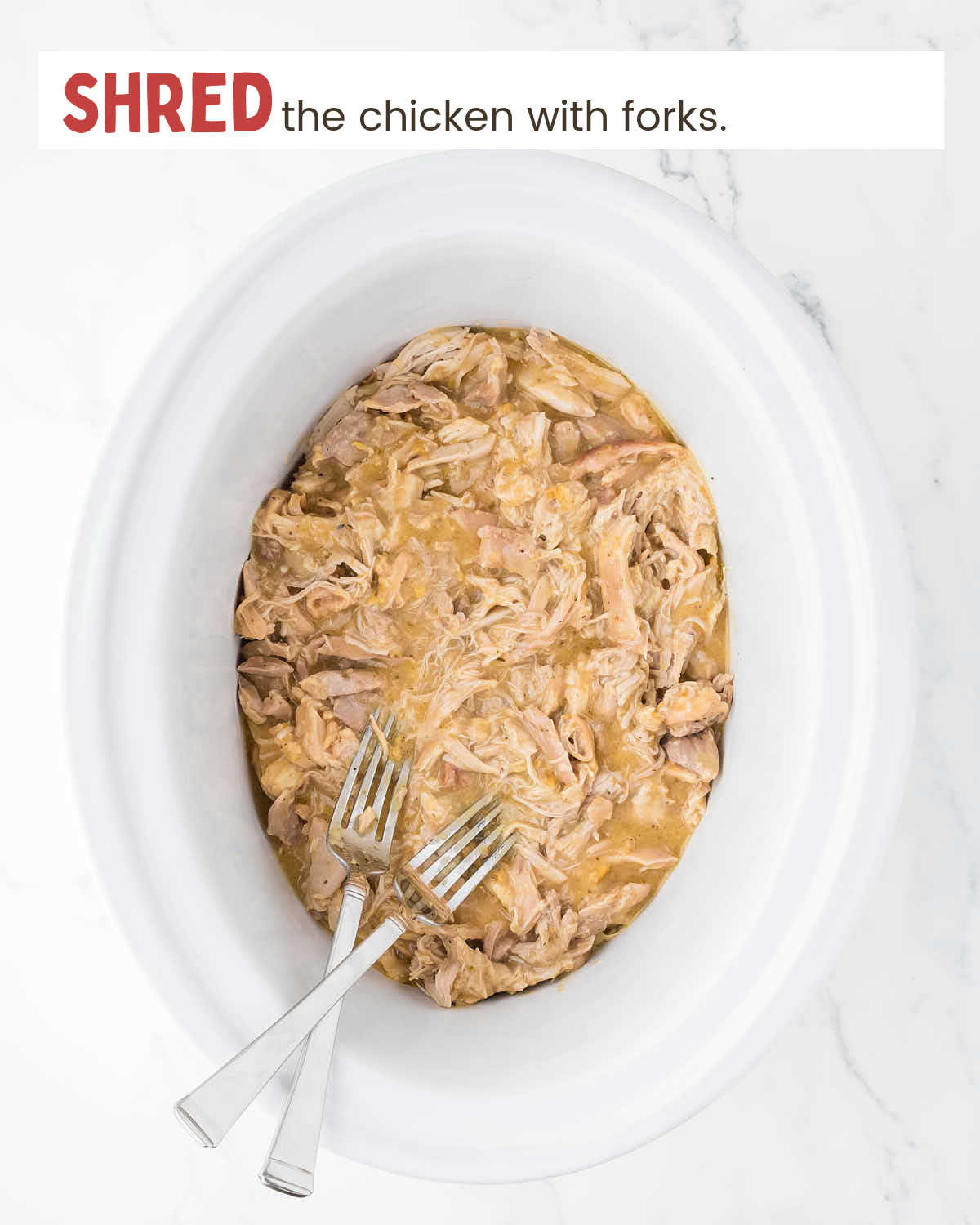 Shredded chicken in gravy in a crockpot.