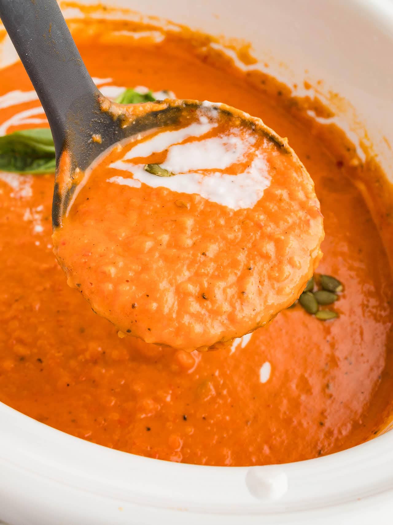 A ladle full of Pumpkin Soup made in the Crockpot.