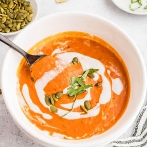 Crockpot Pumpkin Soup served in a white bowl.