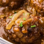 Closeup of a Hamburger Steak a large skillet.