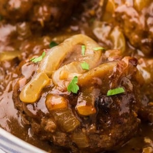 Closeup of a Hamburger Steak a large skillet.