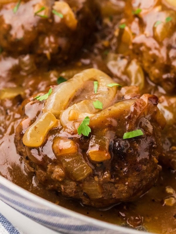 Closeup of a Hamburger Steak a large skillet.