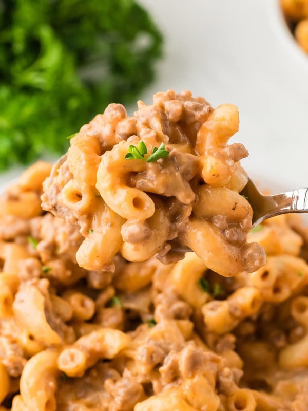 Closeup of a serving spoon filled with Hamburger Helper.