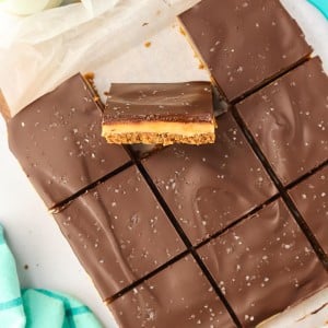 Sliced Millionaire Shortbread with one slice standing upright.