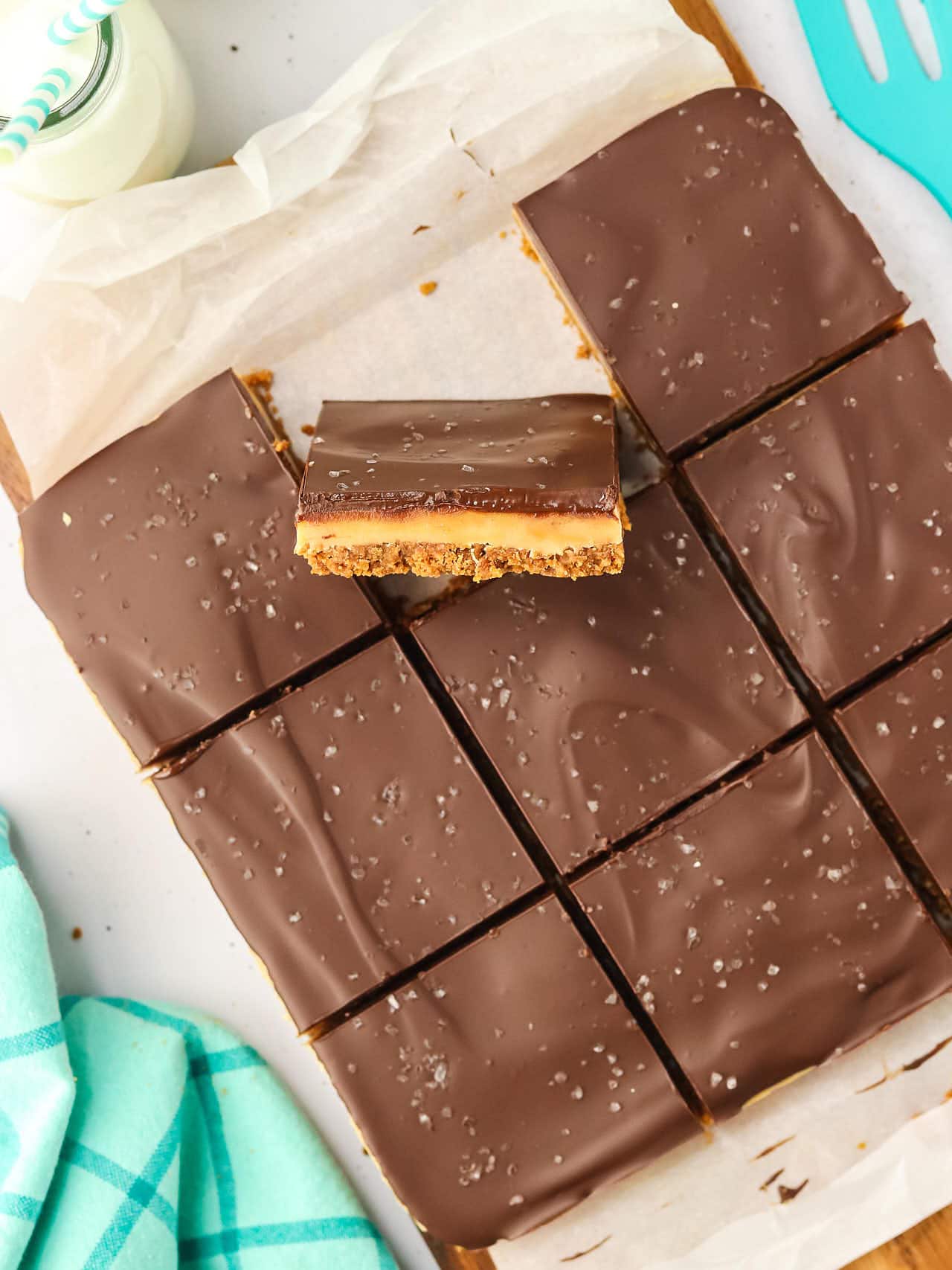 Sliced Millionaire Shortbread with one slice standing upright.