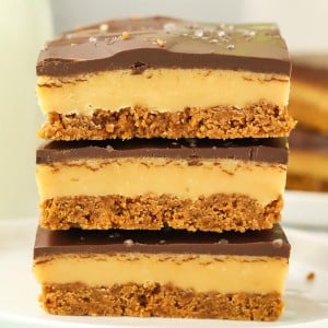 A stack of Millionaire Shortbread slices on a white plate.