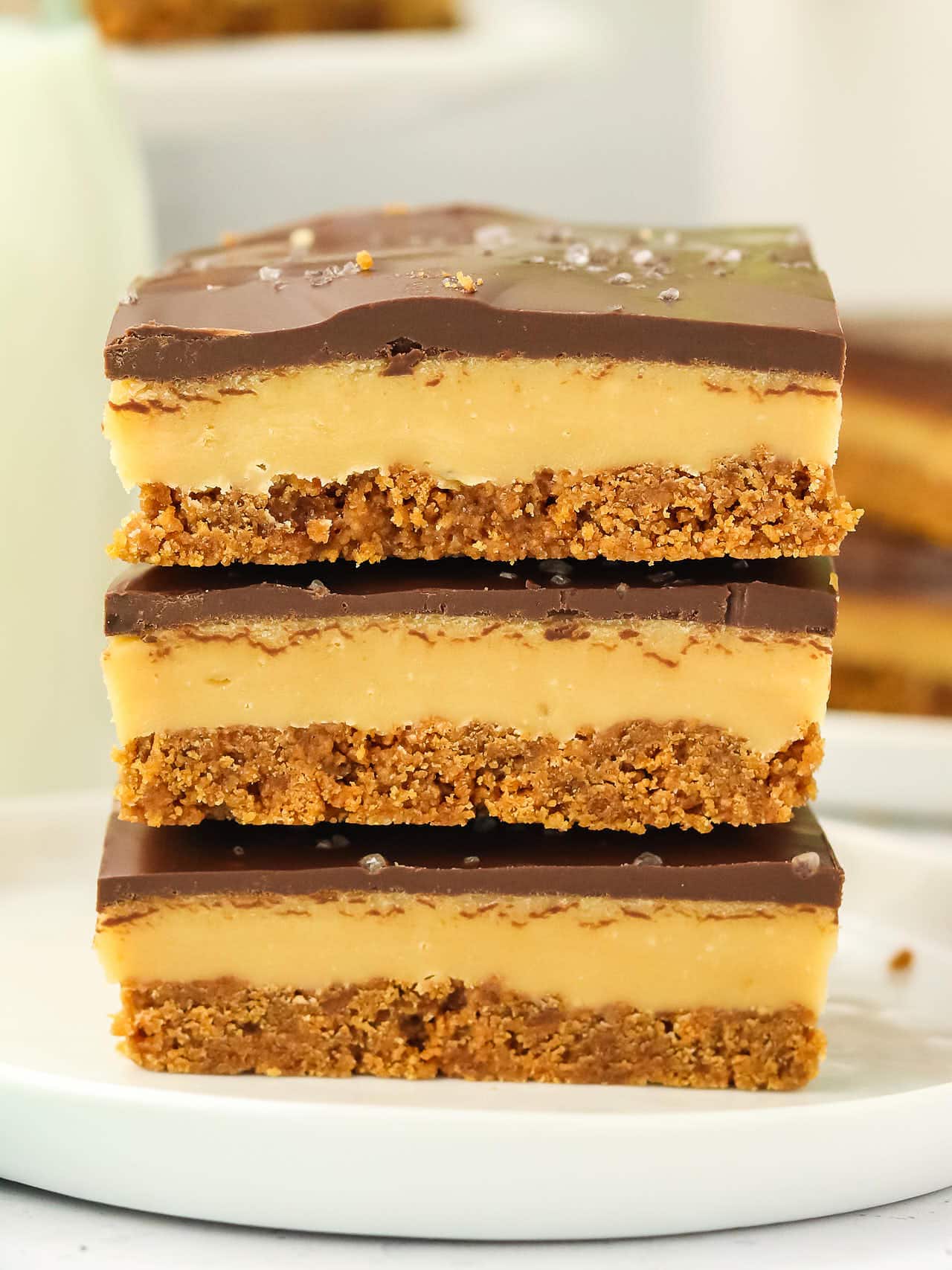 A stack of Millionaire Shortbread slices on a white plate.
