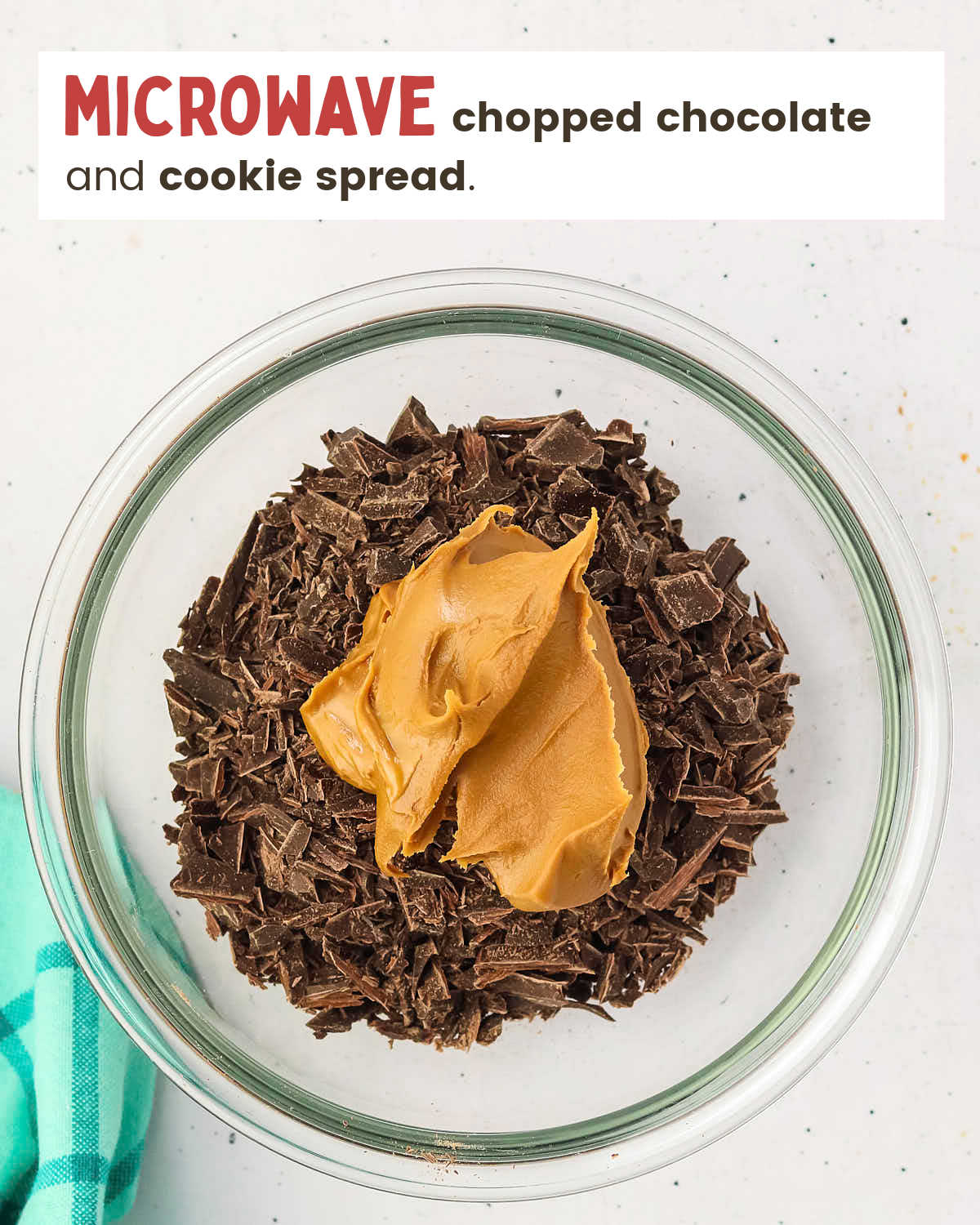 Chopped chocolate topped with Bischoff spread in a glass dish.