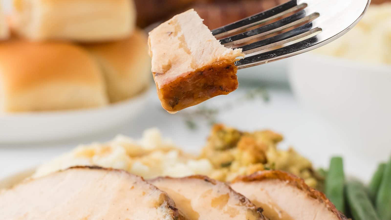 A forkful of Turkey dipped in Turkey Gravy.