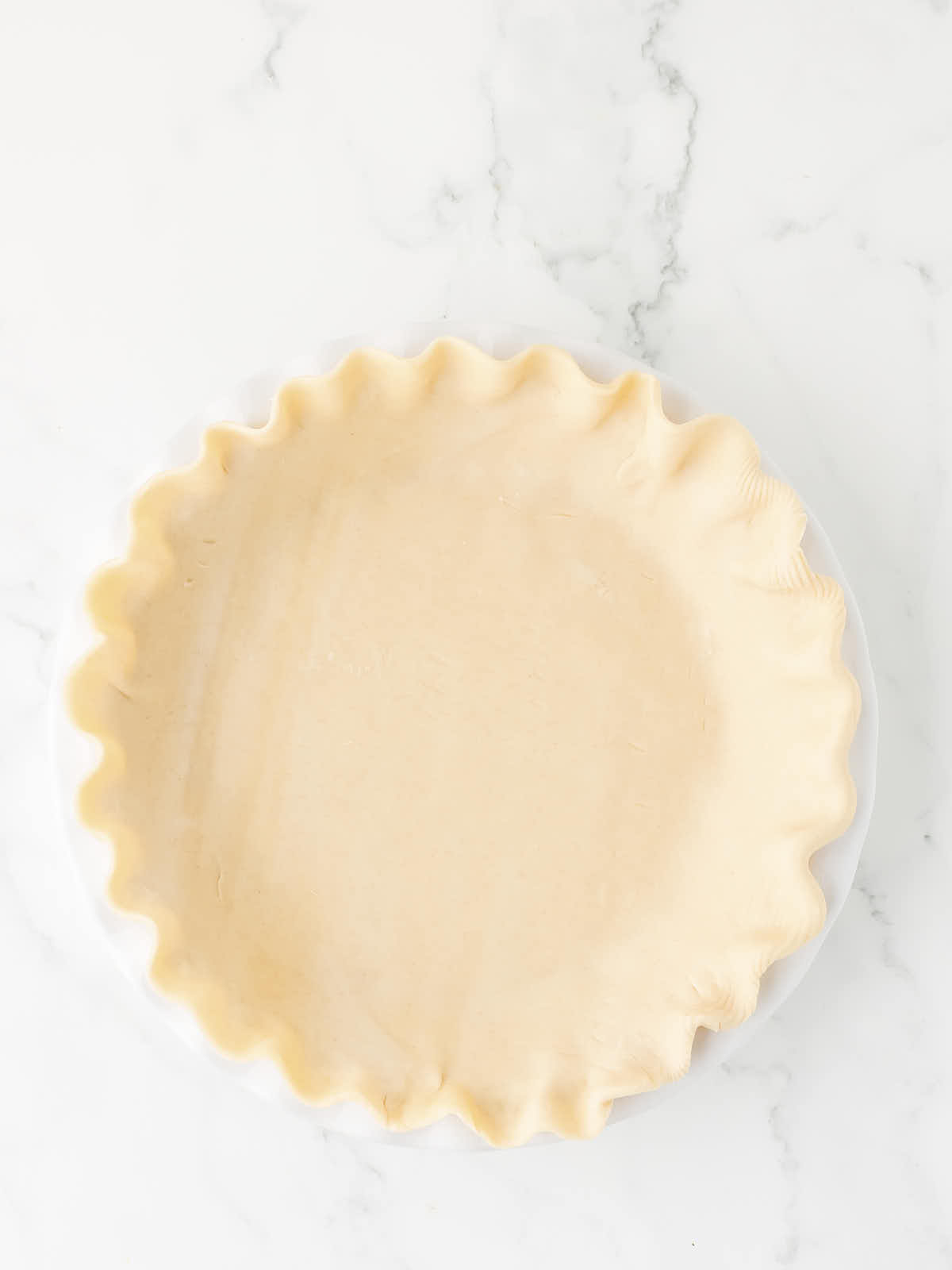 Unbaked pie crust in a pie dish.