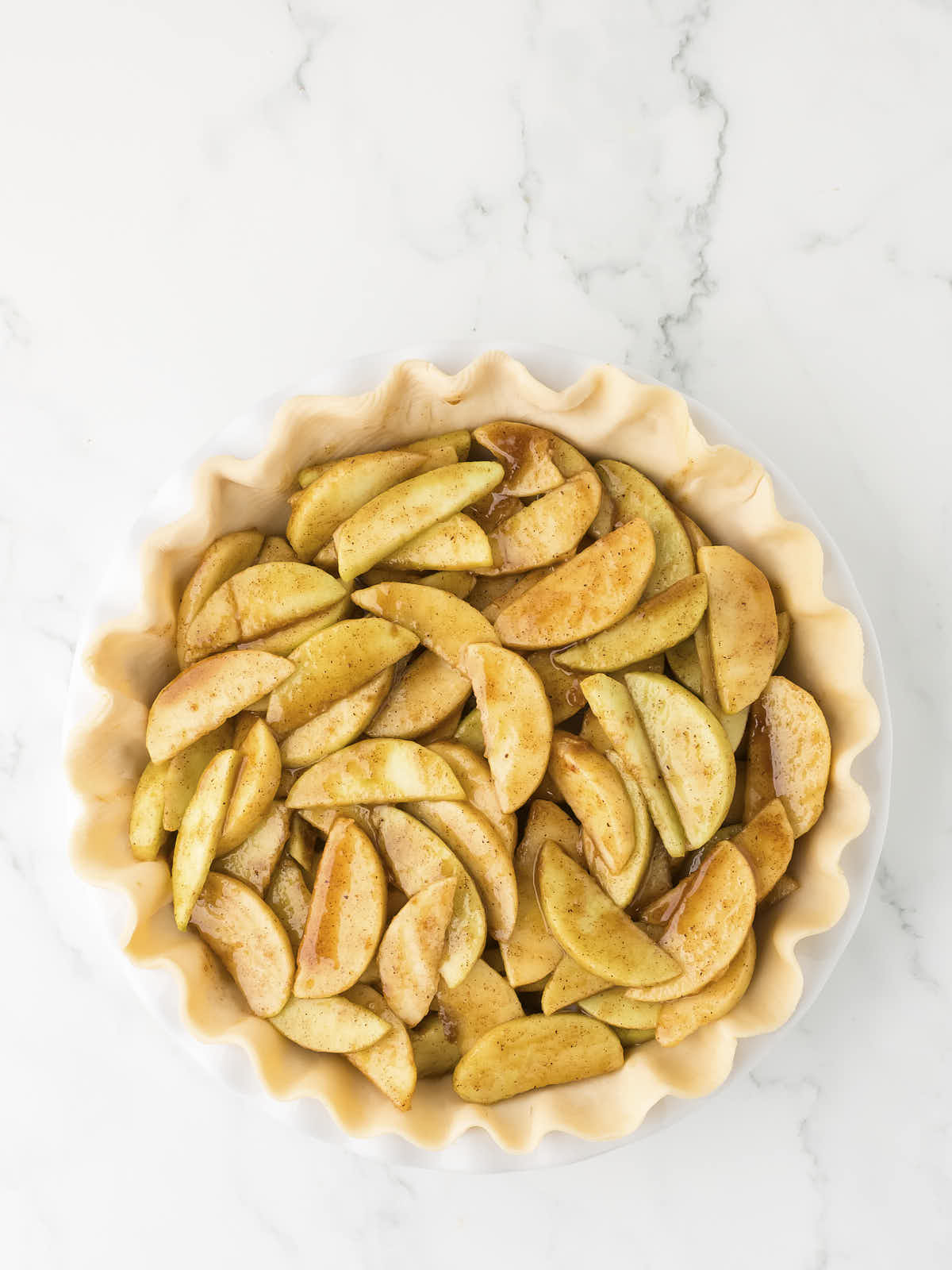 Sliced apples added to the pie crust.