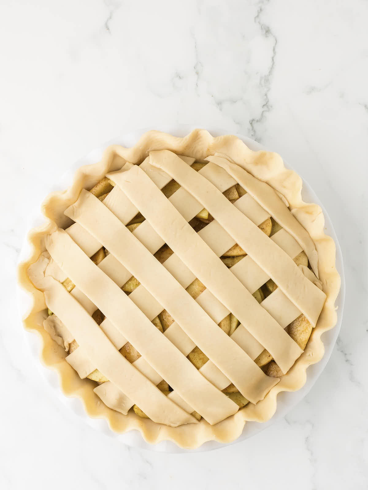 Unbaked Apple Pie with lattice pie crust.