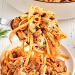 A serving spoon full of Linguini with Clams.