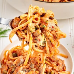 A serving spoon full of Linguini with Clams.