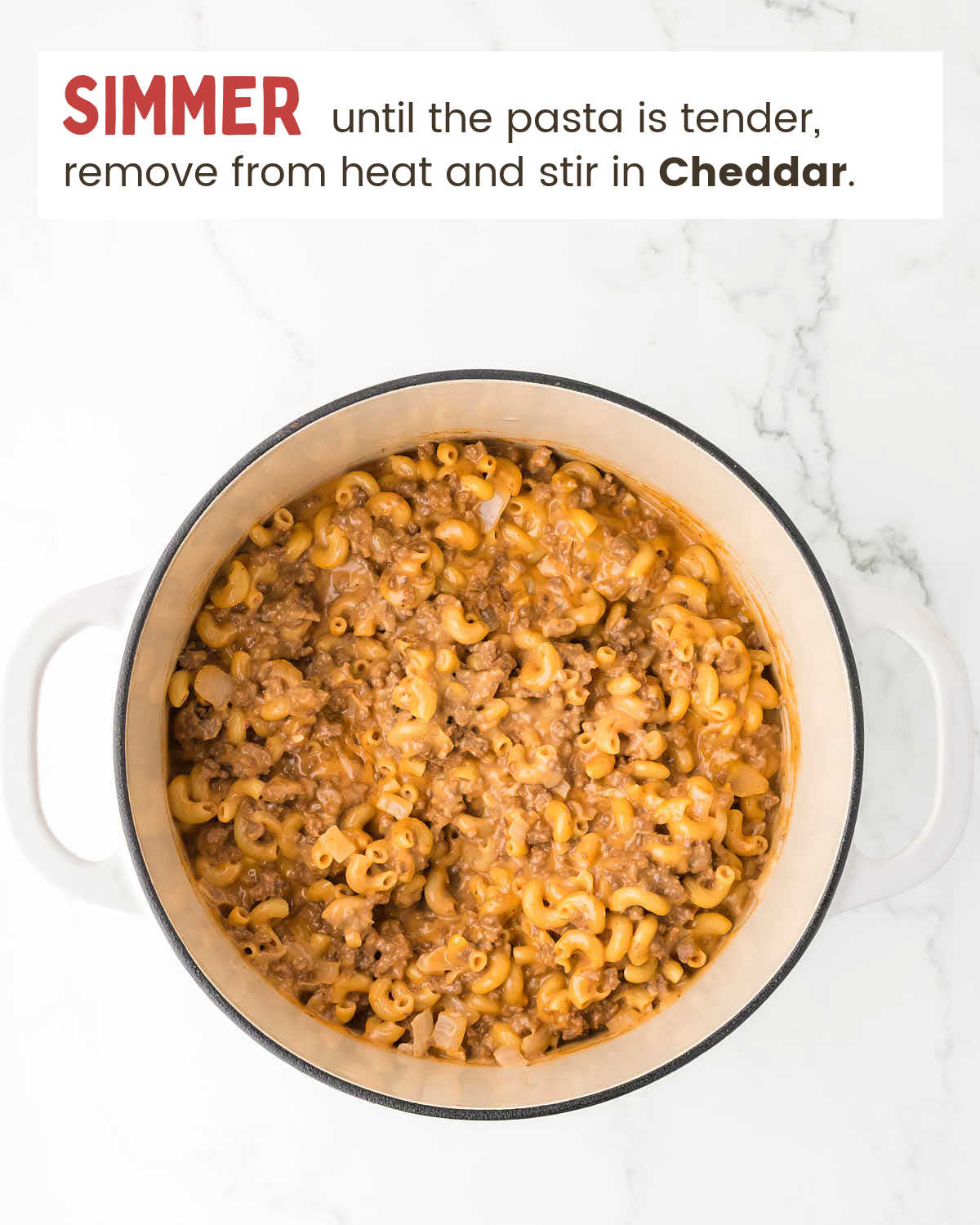 Finishing the pasta with Cheddar cheese.