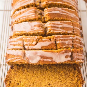 Pumpkin Bread with sugar glaze sliced on a wire cooling rack.