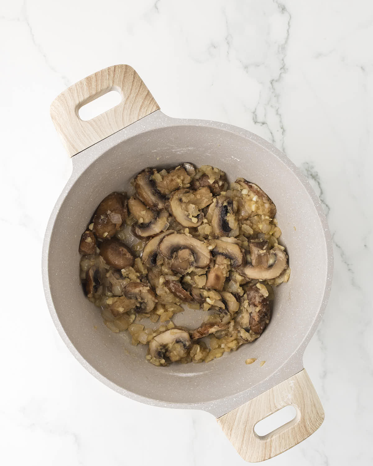 Sautéed mushrooms and onions in a skillet for creamy Turkey Tetrazzini.