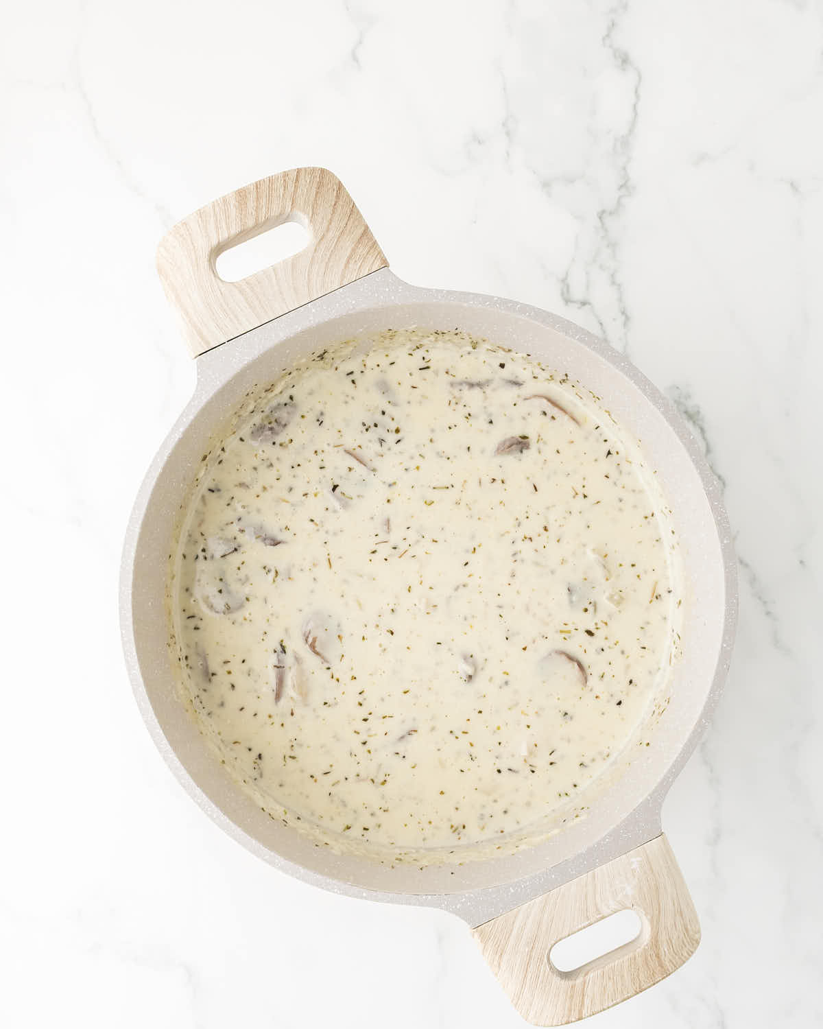Creamy mushroom sauce with herbs for homemade Turkey Tetrazzini.
