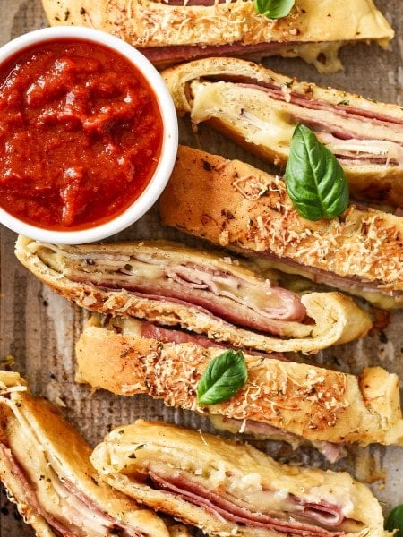 Baked easy Stromboli with basil, and served with marinara sauce.
