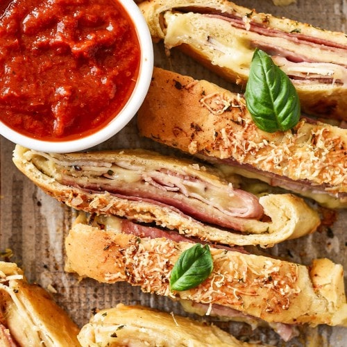 Baked easy Stromboli with basil, and served with marinara sauce.
