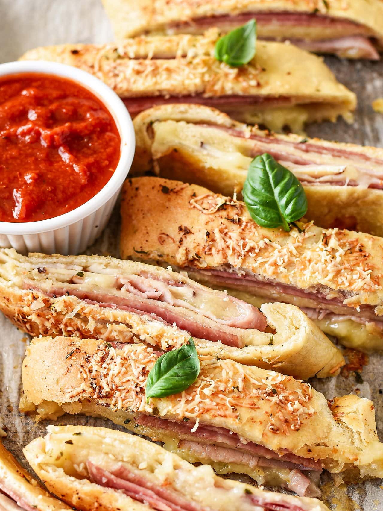 Baked easy Stromboli with basil, and served with marinara sauce.