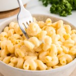Creamy Homemade Mac and Cheese in a bowl with a fork twirling cheesy pasta.