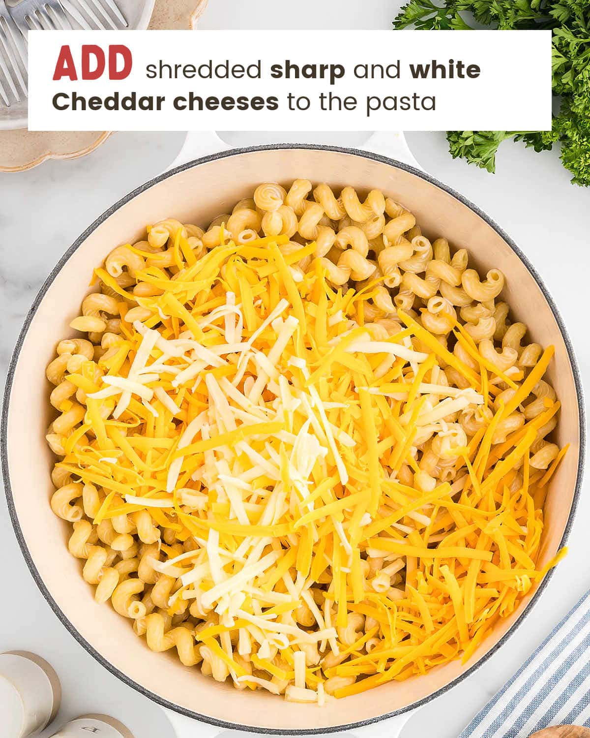 Adding shredded Cheddar cheeses over the pasta. 
