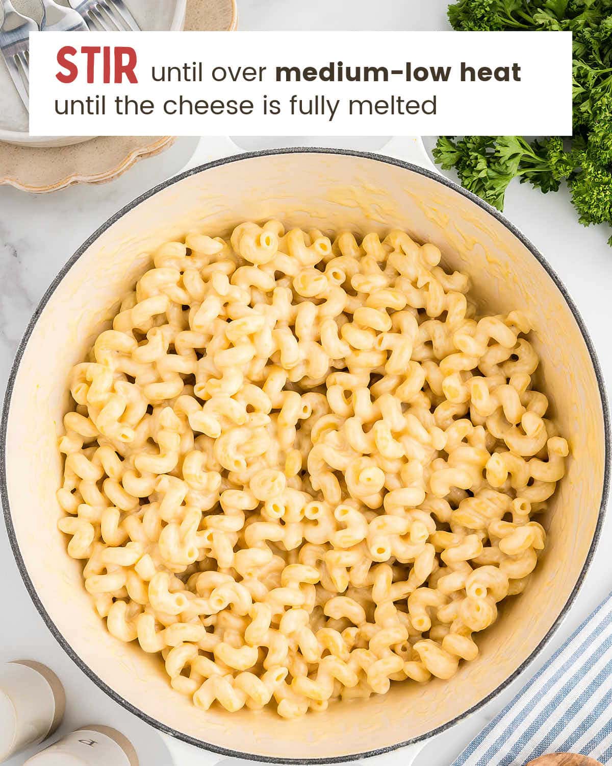 Stirring the pasta until the cheese has melted. 