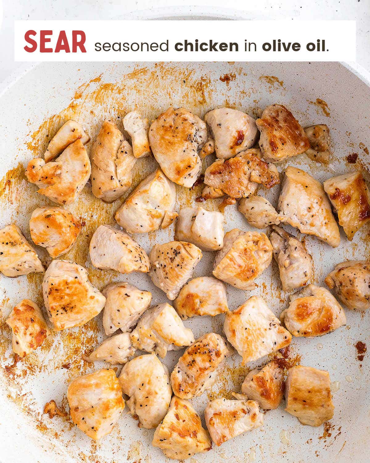 Sear chicken in olive oil in a large skillet.