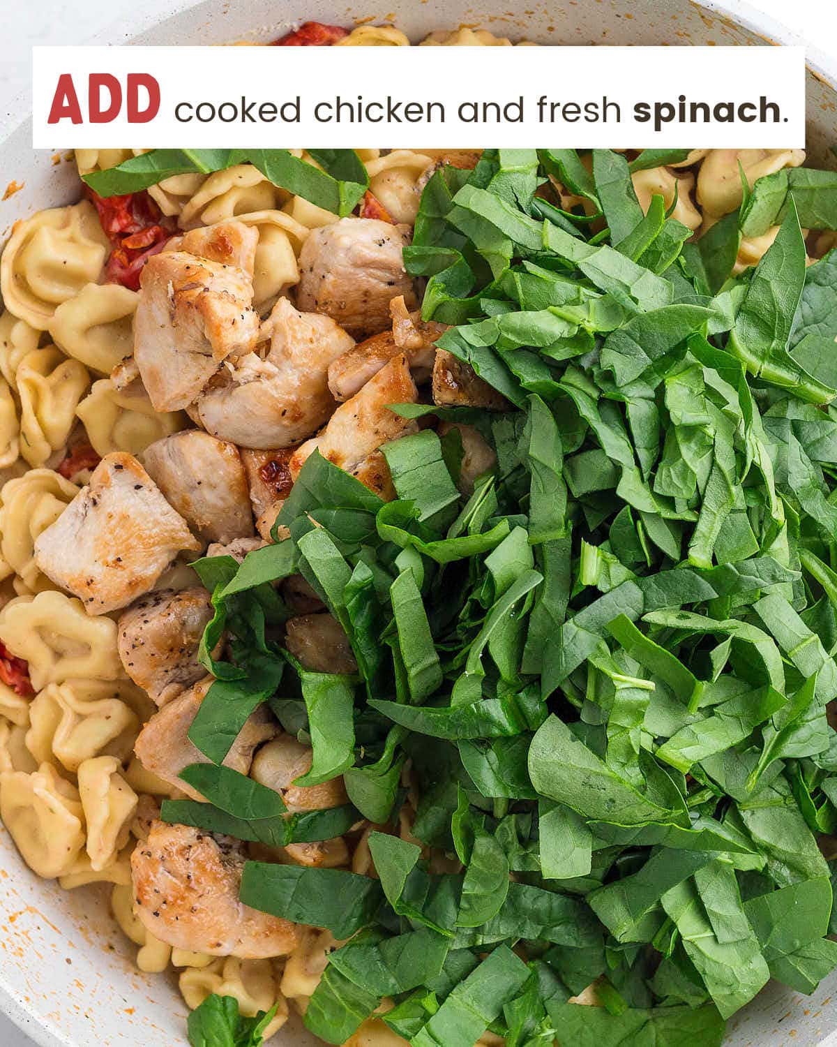 Fold cooked chicken and fresh spinach.