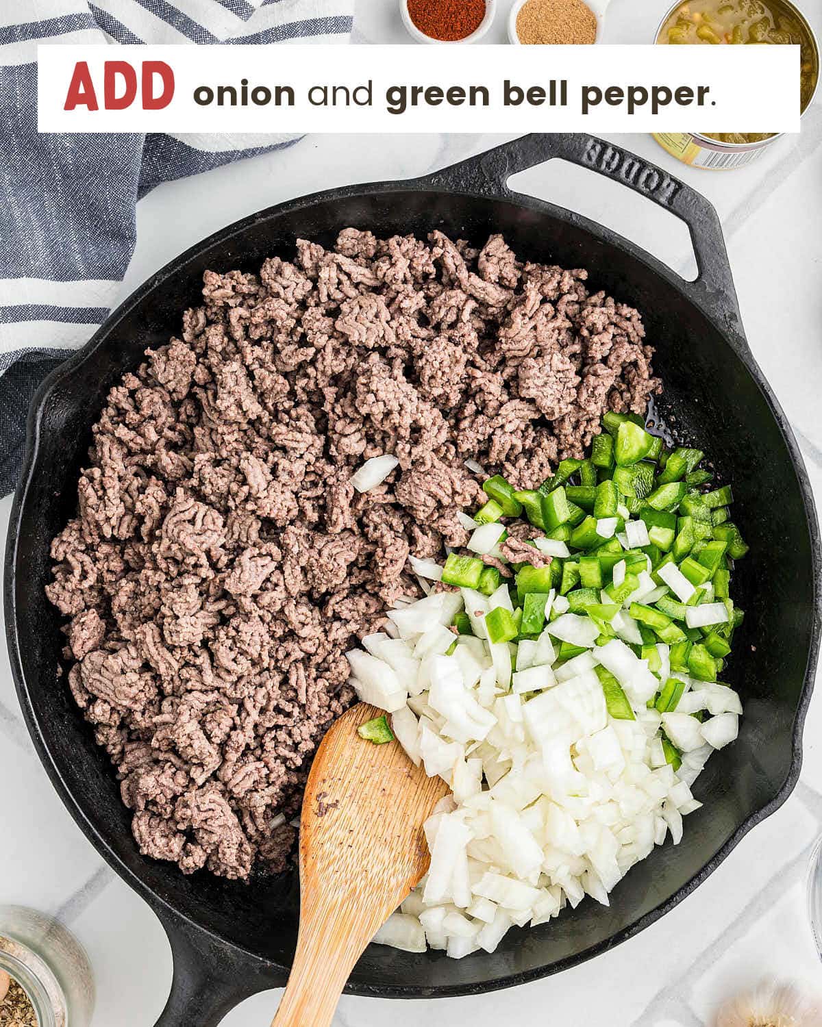 Diced onions and green bell peppers added to the cast iron skillet.