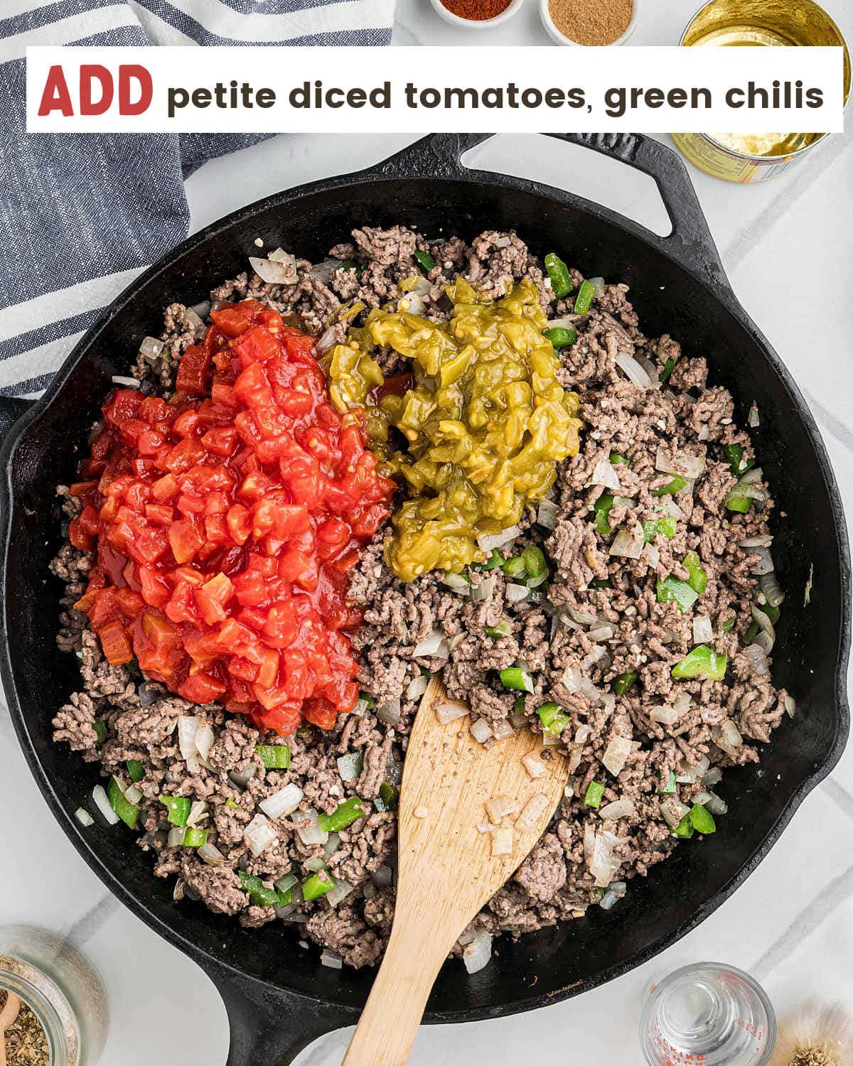 Petit diced tomatoes and green chilies being added to the cast iron skillet.