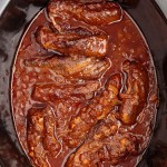 Boneless Beef Short Ribs made in a black slow cooker.