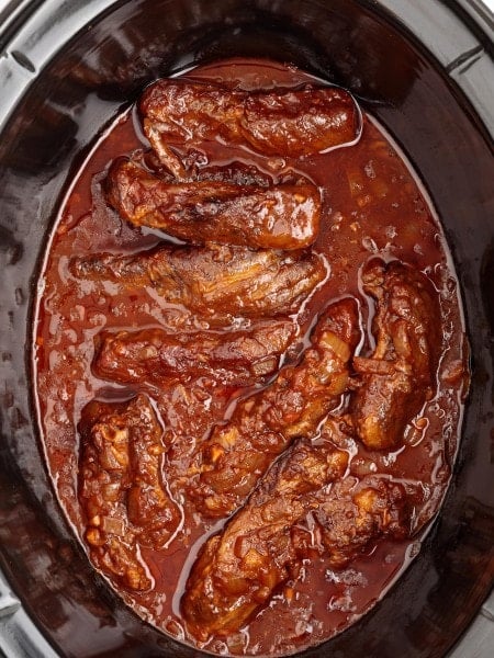 Boneless Beef Short Ribs made in a black slow cooker.