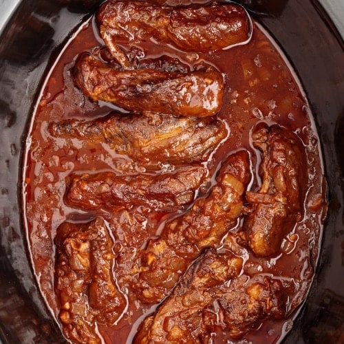 Boneless Beef Short Ribs made in a black slow cooker.