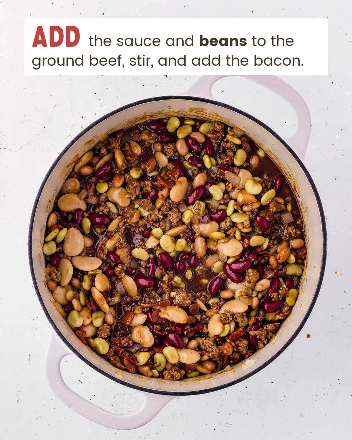 Beans, bacon, and sauce added to the ground beef skillet.
