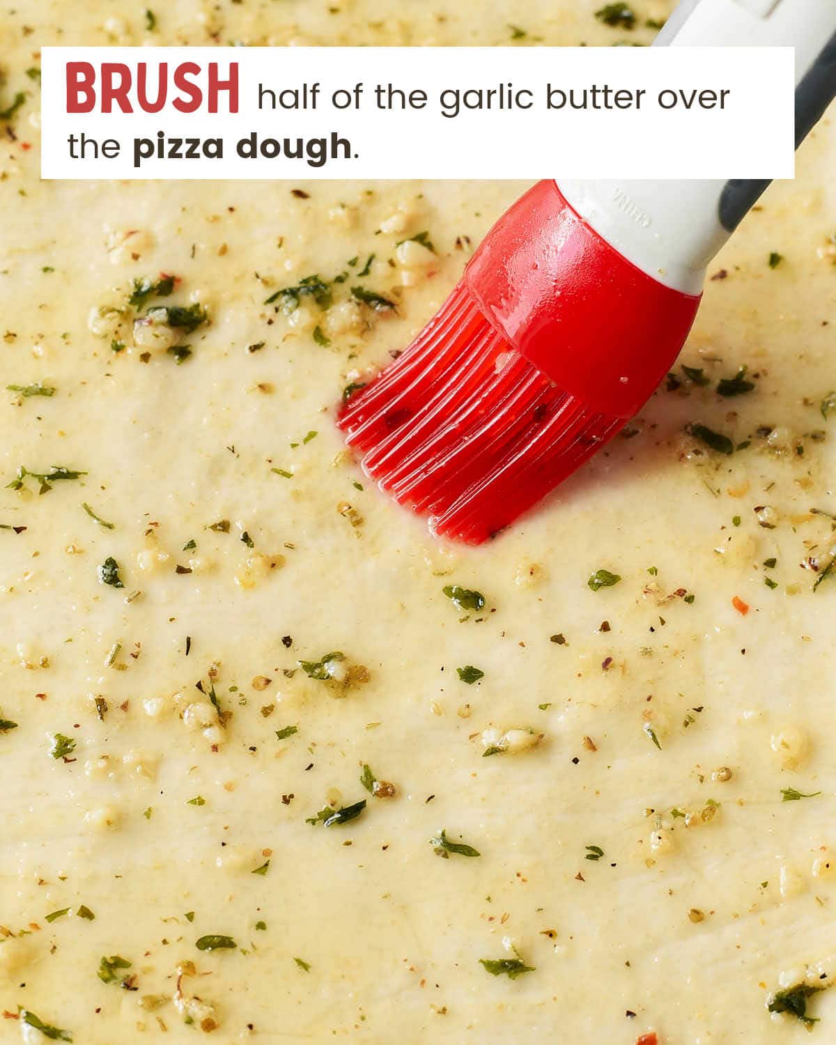 Brush melted garlic butter over the pizza dough.