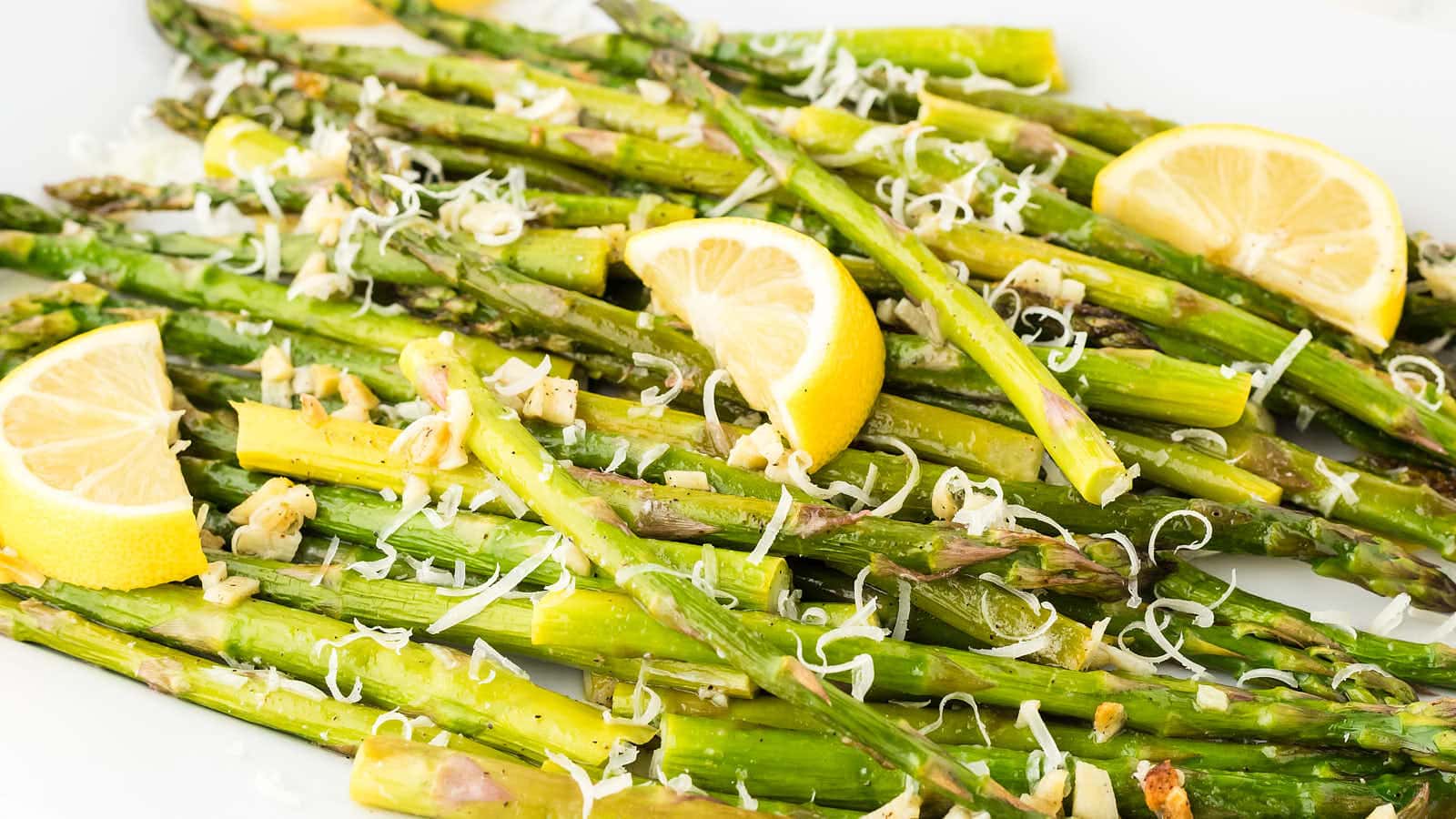 Closeup of Oven Roasted Asparagus served on a white plate.