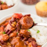 A bowl of rice and beans served on a white plate.