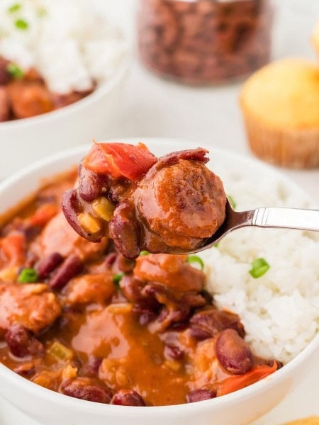 A bowl of rice and beans served on a white plate.
