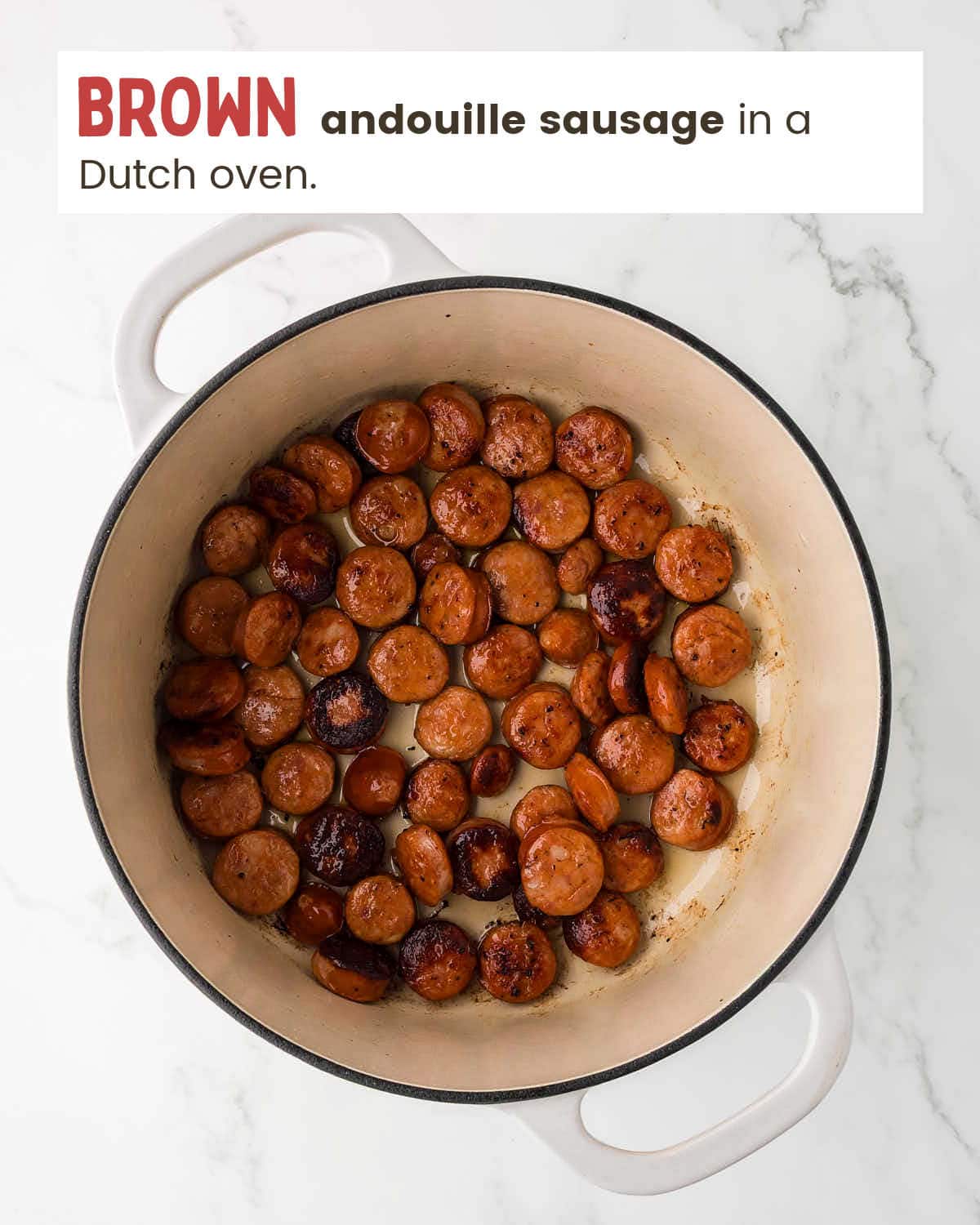 Browned andouille sausage in a Dutch oven.