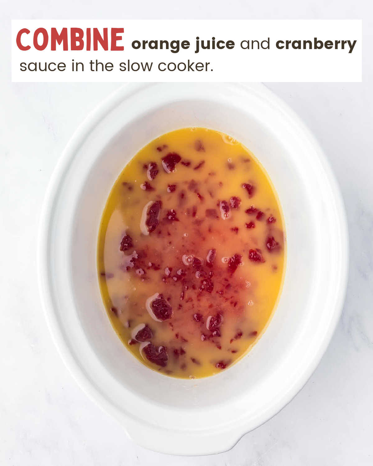 Combined orange juice and cranberries in a slow cooker.